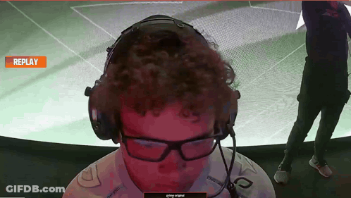 A Man Wearing Headphones And Glasses Is Watching A Replay On A Screen GIF