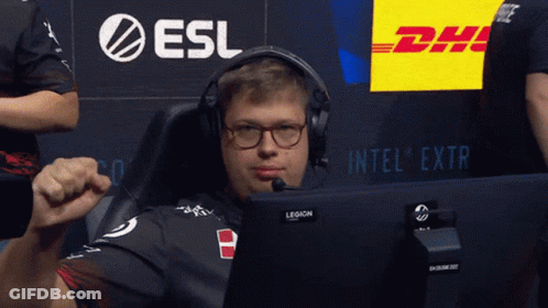 A Man Wearing Headphones And Glasses Sits In Front Of A Dhl Sign GIF