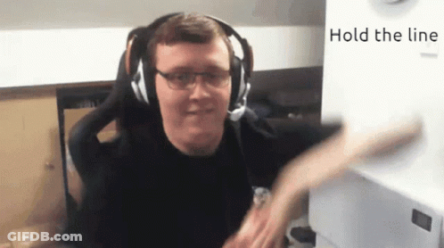 A Man Wearing Headphones And Glasses With The Words Hold The Line Behind Him GIF