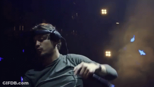 A Man Wearing Headphones And Holding A Microphone GIF