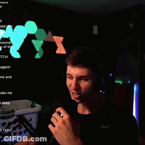 A Man Wearing Headphones And Holding A Microphone In Front Of A Screen That Says " Yt " GIF