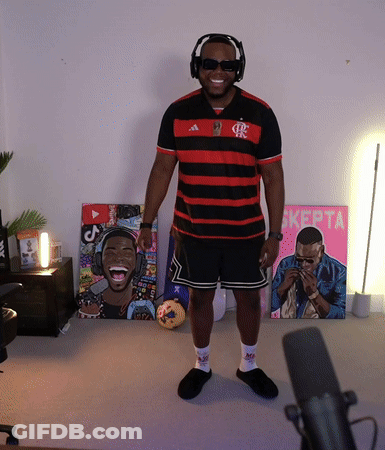 A Man Wearing Headphones And Sunglasses Stands In Front Of A Pink Sign That Says ' Kepta ' GIF