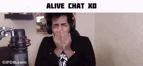 A Man Wearing Headphones Covering His Mouth With His Hands In Front Of A Microphone With The Words Alive Chat Xd Below H GIF