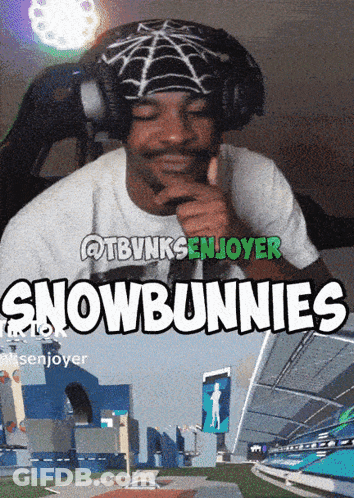A Man Wearing Headphones Giving A Thumbs Up In Front Of A Sign That Says " Snowbunnies " GIF