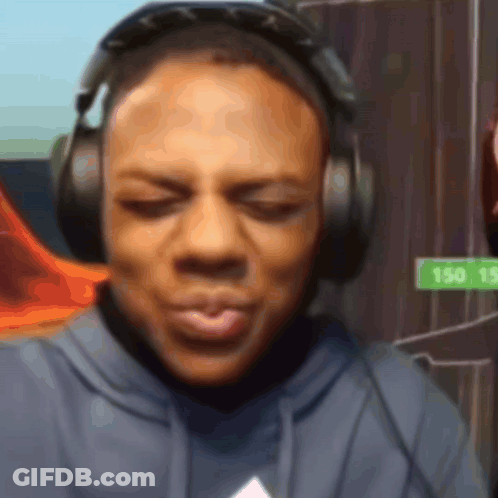 A Man Wearing Headphones Has A Sign That Says 150 15 In The Background GIF