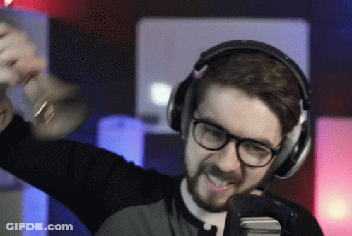 A Man Wearing Headphones Holds A Trumpet In His Hand GIF