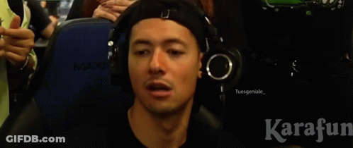 A Man Wearing Headphones Is Blowing Into A Pink Whistle GIF