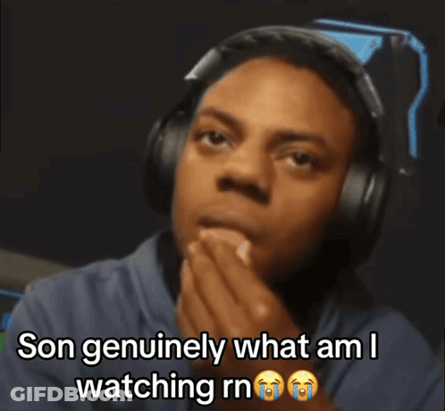 A Man Wearing Headphones Is Covering His Mouth And Says Son Genuinely What Am I Watching Rn GIF