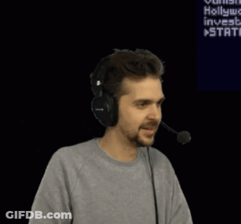 A Man Wearing Headphones Is Dancing In Front Of A Screen That Says " Hollywood Invests " GIF