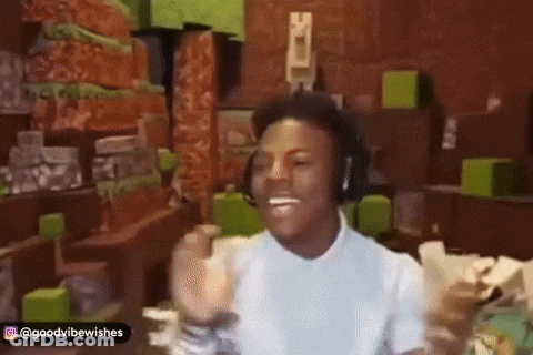 A Man Wearing Headphones Is Giving A Thumbs Up In A Room GIF