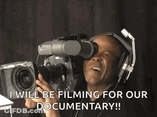 A Man Wearing Headphones Is Holding A Camera And Says I Will Be Filming For Our Documentary GIF