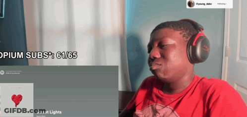 A Man Wearing Headphones Is Looking At A Screen That Says ' Opium Subs ' On It GIF