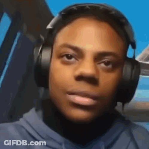 A Man Wearing Headphones Is Looking At The Camera . GIF