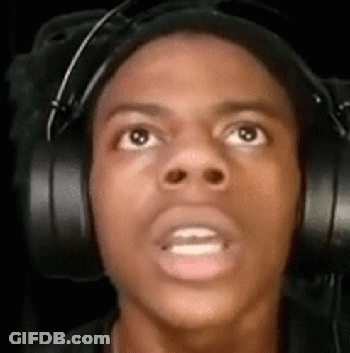 A Man Wearing Headphones Is Looking Up At The Camera . GIF