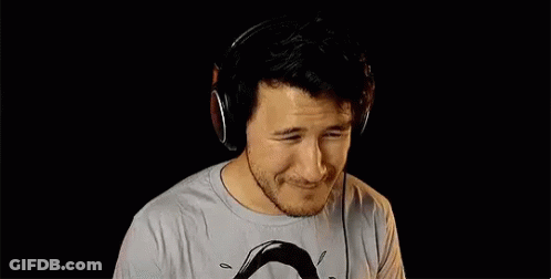 A Man Wearing Headphones Is Making A Funny Face . GIF