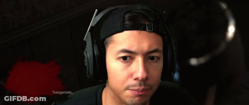 A Man Wearing Headphones Is Making A Funny Face In Front Of A Bloody Background That Says Tuesgeniuse GIF