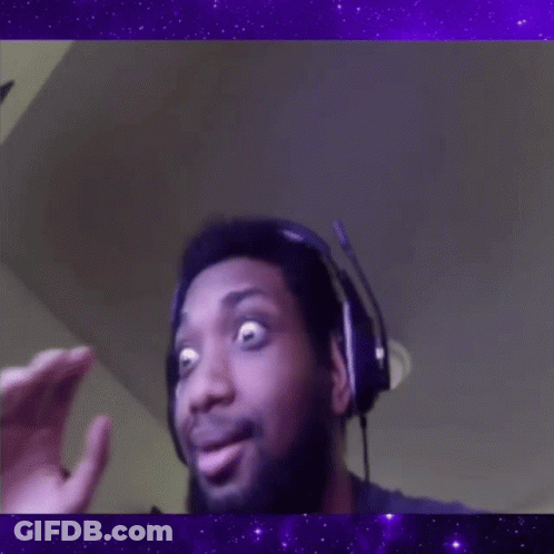 A Man Wearing Headphones Is Making A Funny Face In Front Of A Purple Background . GIF