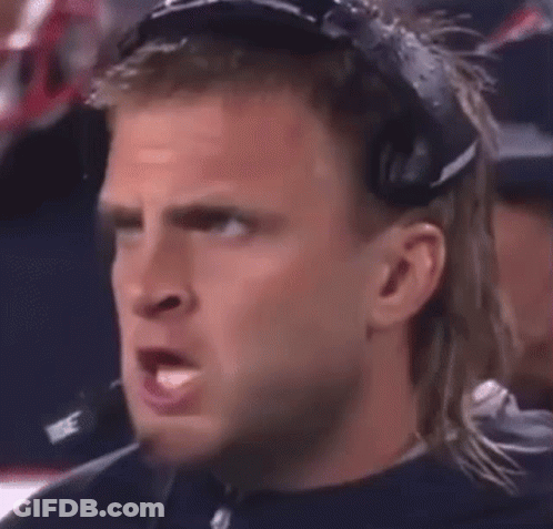 A Man Wearing Headphones Is Making A Funny Face . GIF