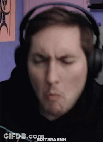 A Man Wearing Headphones Is Making A Funny Face GIF