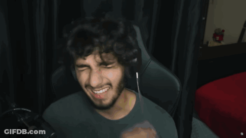 A Man Wearing Headphones Is Making A Funny Face Under The Words Tweaking GIF