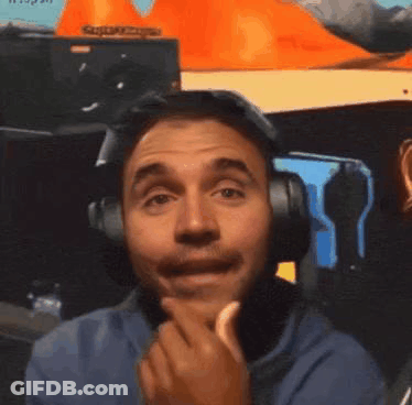 A Man Wearing Headphones Is Making A Funny Face While Eating A Banana . GIF