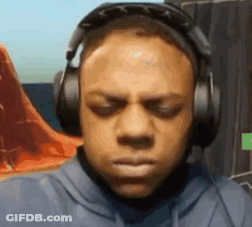 A Man Wearing Headphones Is Making A Funny Face While Playing A Video Game . GIF