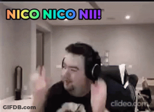 A Man Wearing Headphones Is Making A Funny Face While Sitting In A Chair . GIF