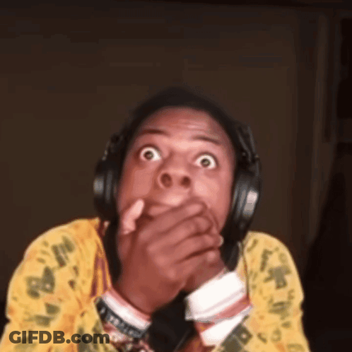 A Man Wearing Headphones Is Making A Surprised Face GIF