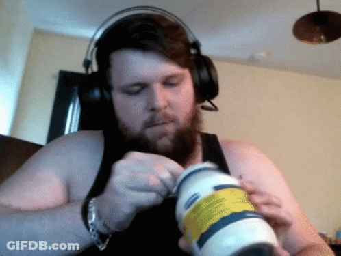 A Man Wearing Headphones Is Opening A Bottle Of Lotion GIF