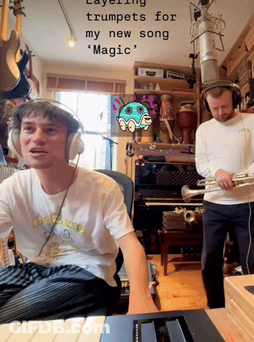 A Man Wearing Headphones Is Playing A Trumpet While Another Man Plays A Piano GIF