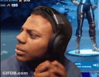 A Man Wearing Headphones Is Playing A Video Game And Making A Funny Face . GIF