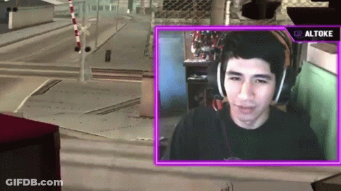 A Man Wearing Headphones Is Playing A Video Game With A Purple Overlay That Says ' Altos ' On It GIF