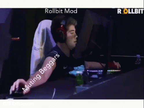 A Man Wearing Headphones Is Playing A Video Game With The Words Rollbit Mod Muting Beggars GIF