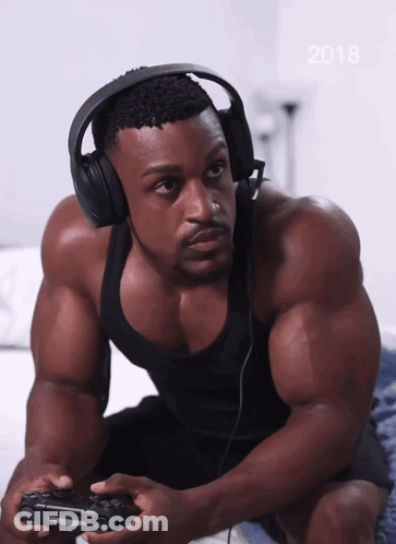 A Man Wearing Headphones Is Playing A Video Game With The Year 2018 On The Bottom GIF