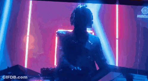 A Man Wearing Headphones Is Playing Music In Front Of A Sign That Says ' Rockstar ' GIF
