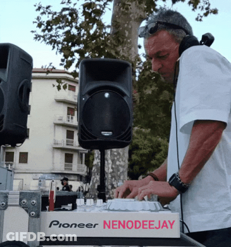 A Man Wearing Headphones Is Playing Music On A Pioneer Nenodeejay Machine GIF