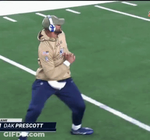 A Man Wearing Headphones Is Running On A Football Field With The Name Dak Prescott At The Bottom GIF