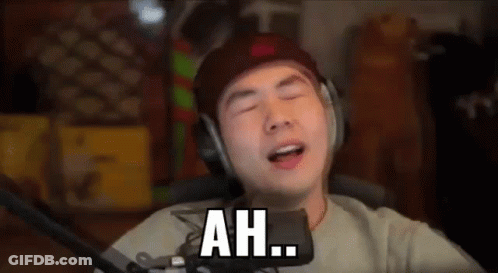 A Man Wearing Headphones Is Singing Into A Microphone And Saying `` Ah '' . GIF