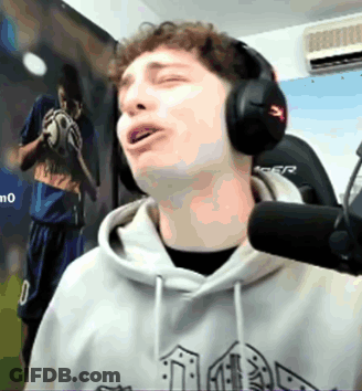 A Man Wearing Headphones Is Singing Into A Microphone In Front Of A Picture Of A Soccer Player Holding A Ball GIF