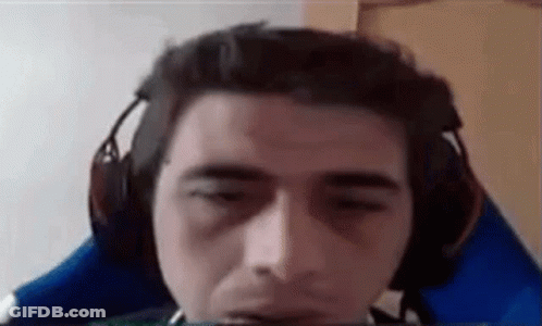 A Man Wearing Headphones Is Sitting In A Blue Chair . GIF