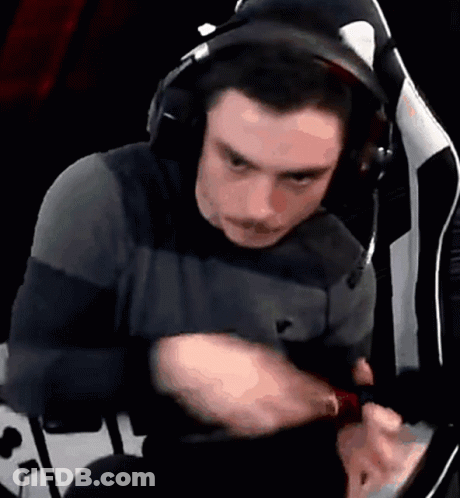 A Man Wearing Headphones Is Sitting In A Chair And Looking At Something GIF