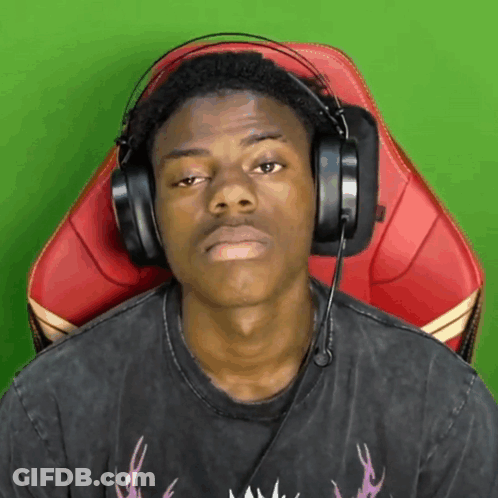 A Man Wearing Headphones Is Sitting In A Chair With A Green Background GIF