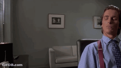 A Man Wearing Headphones Is Sitting In A Chair With His Eyes Closed . GIF