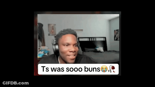 A Man Wearing Headphones Is Sitting In Front Of A Bed In A Room . GIF