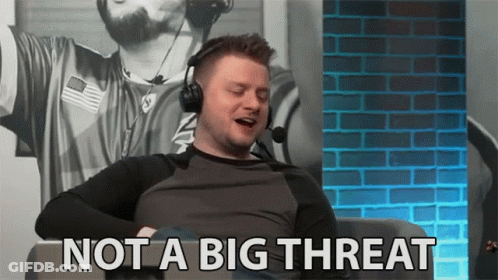 A Man Wearing Headphones Is Sitting In Front Of A Brick Wall And Says Not A Big Threat . GIF