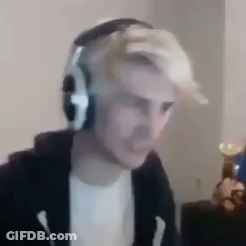 A Man Wearing Headphones Is Sitting In Front Of A Computer Monitor . GIF