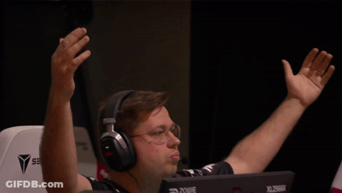 A Man Wearing Headphones Is Sitting In Front Of A Computer Monitor That Says Xl2666k GIF