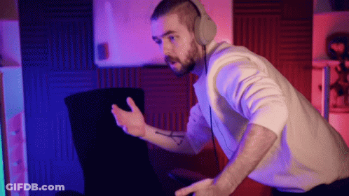 A Man Wearing Headphones Is Sitting In Front Of A Computer Screen GIF