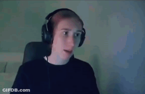 A Man Wearing Headphones Is Sitting In Front Of A Computer Screen . GIF