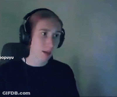 A Man Wearing Headphones Is Sitting In Front Of A Computer Screen . GIF